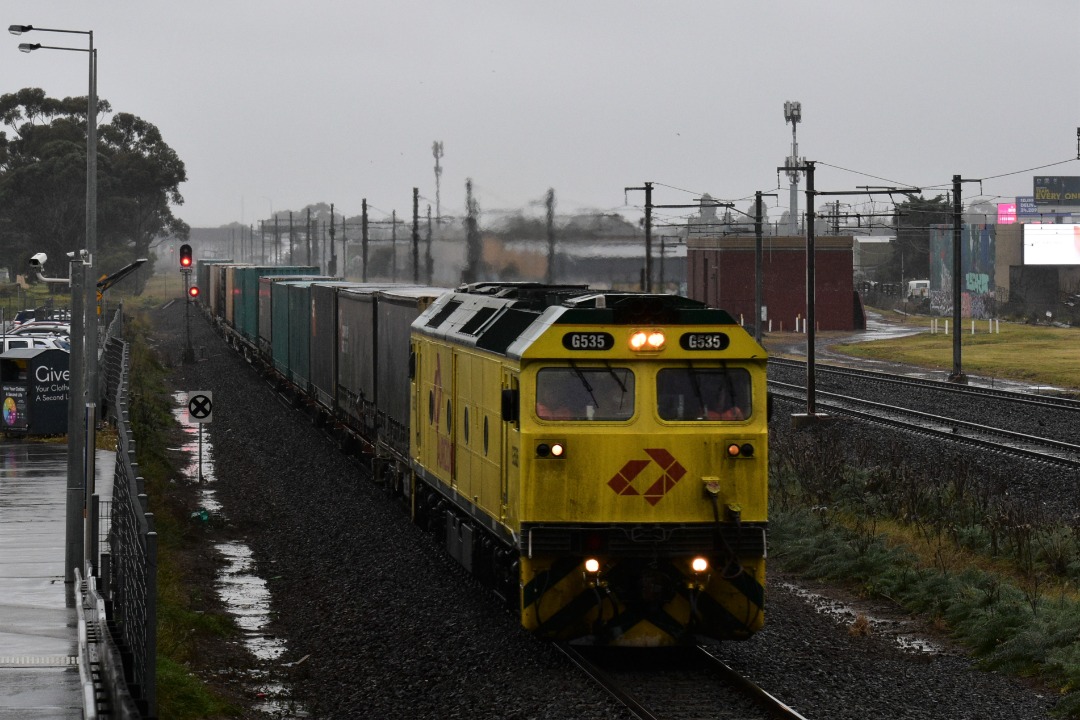 Shawn Stutsel on Train Siding: In wet, cold weather conditions, Aurizon's G535 races through Williams Landing, Melbourne, with the second half of 3MP1
heading for...