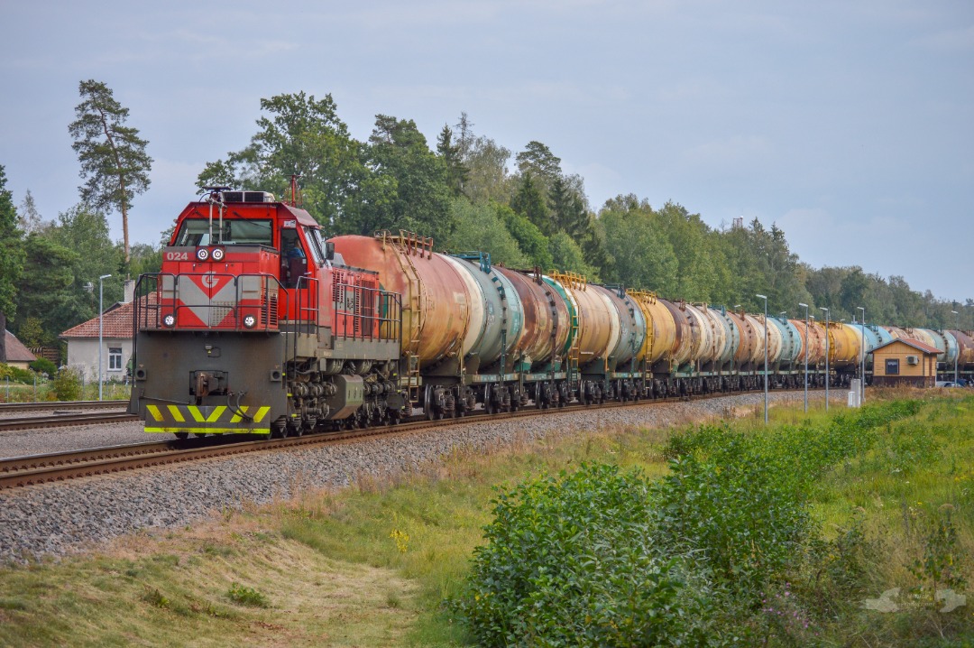 Adam L. on Train Siding: A Russian/Lithuanian joint venture built TEM TMH Class road switcher numbered 024 is seen pulling out of the Mockava yard with a string
of...