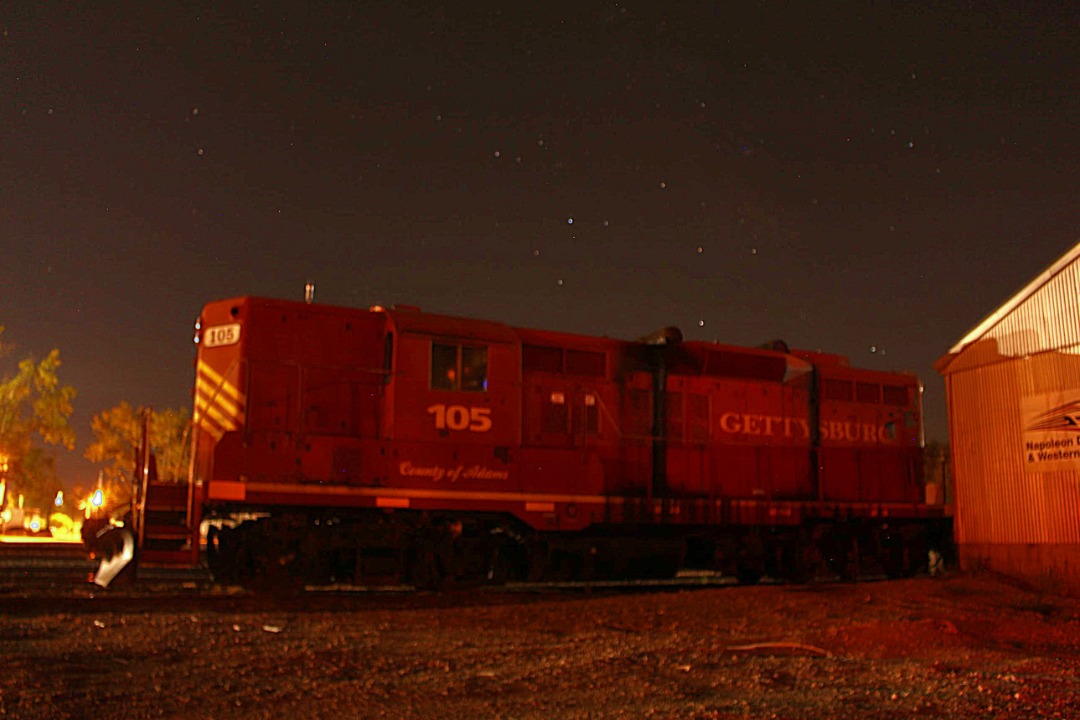 Mason Halsey on Train Siding: Napolean Defiance and Wetsern Locomotives sit quietly in Defiance, Ohio on a warm July, 2024 Night.