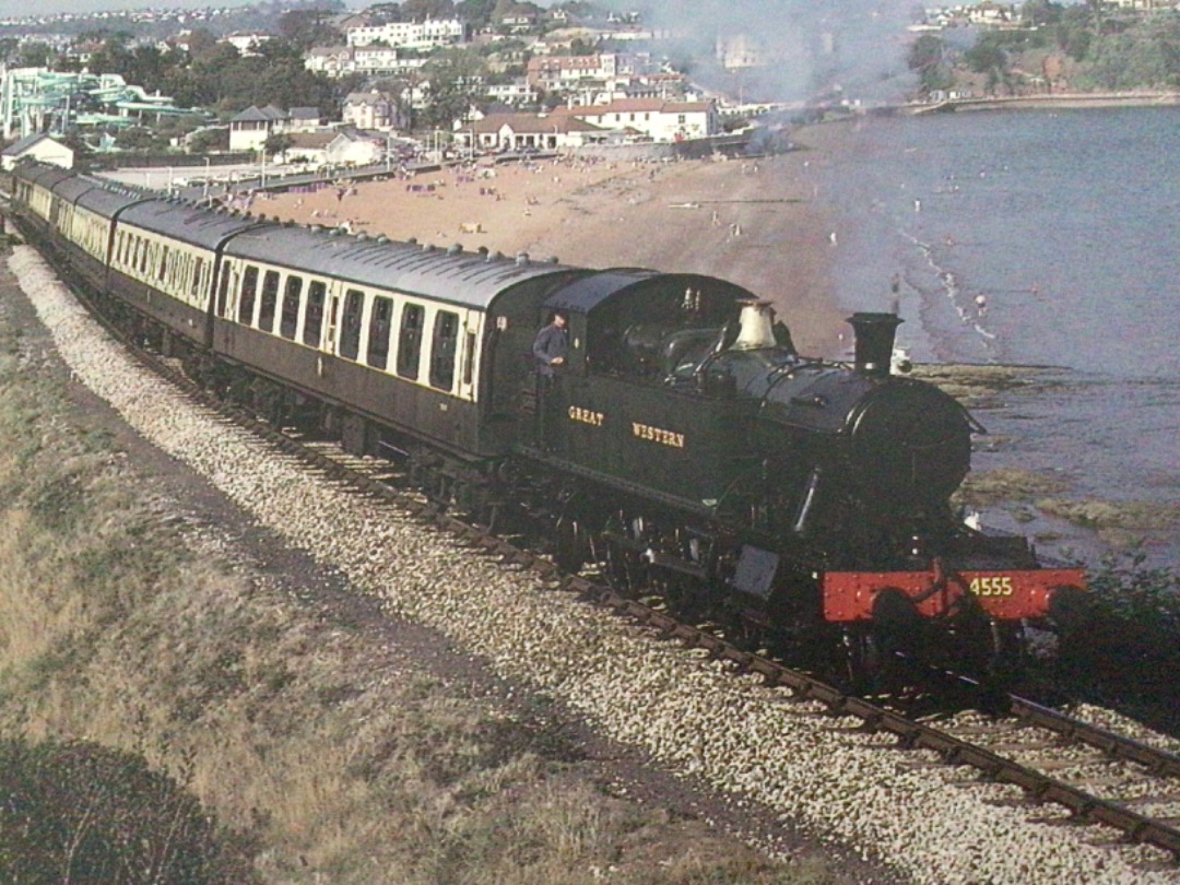 Alex Coomber on Train Siding: A GWR small wheeled prairie tank No. 4555 climbs away from the beach at Goodrington providing passengers with panoramic views
across Torbay.