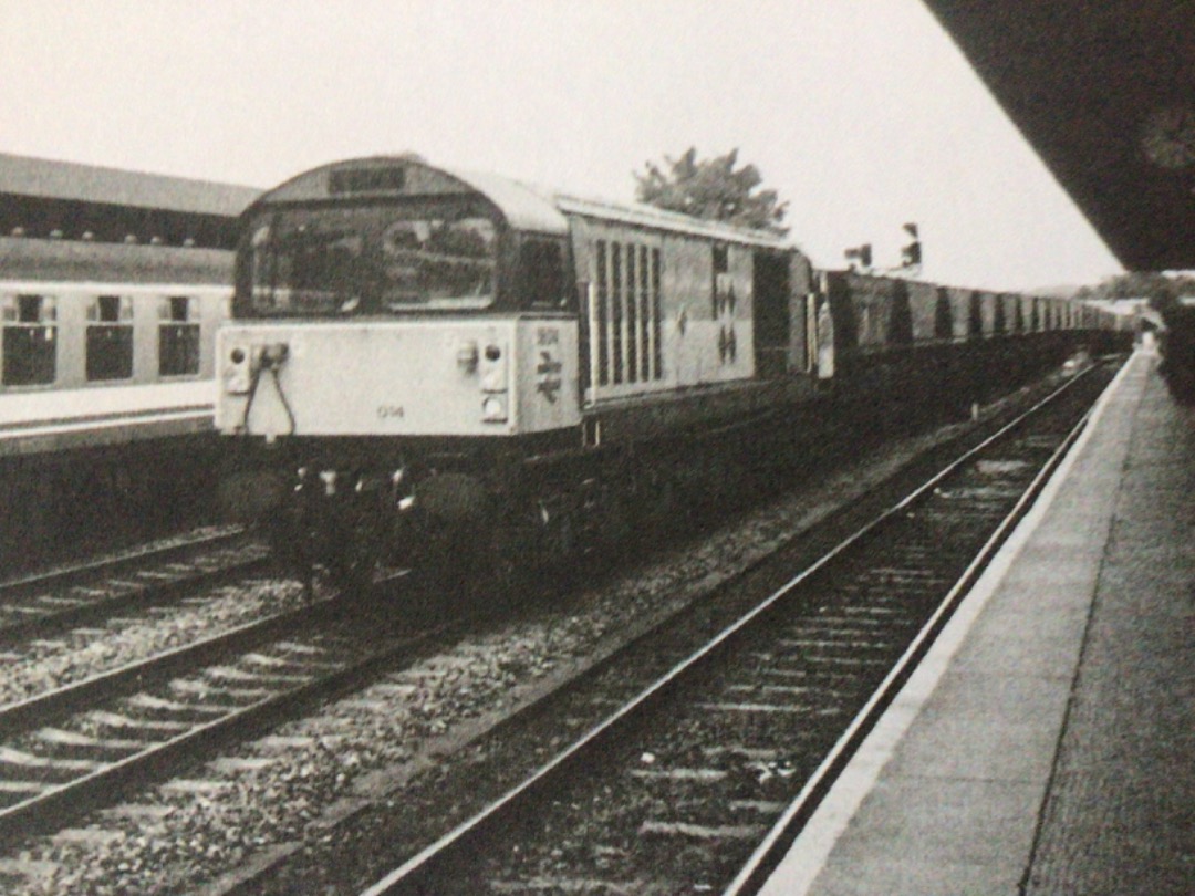 Alex Coomber on Train Siding: A Class 58. 58012 Didcot Power Station sporting the black diamonds for the coal sector. No. 58012 races with empty coal hoppers
through...