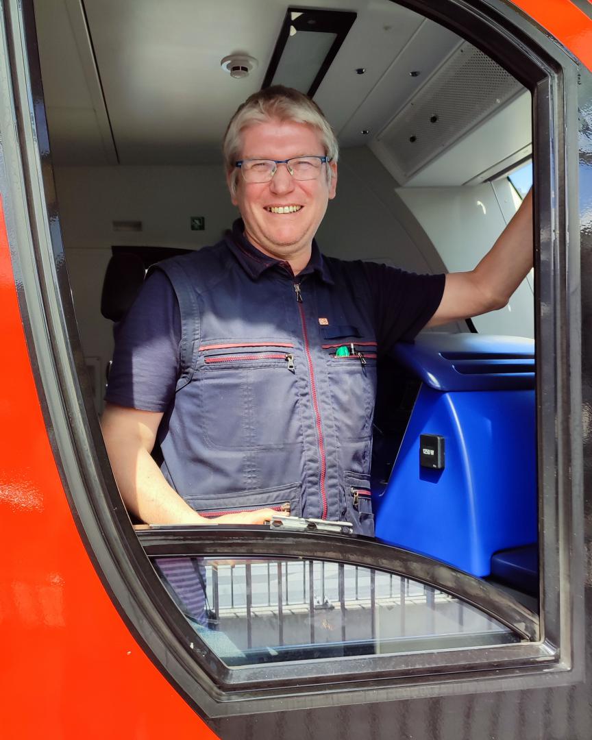 Christian Deysson on Train Siding: Main-Ried-Express to Frankfurt awaiting departure in Wiesloch-Walldorf with good humored driver getting ready to start.