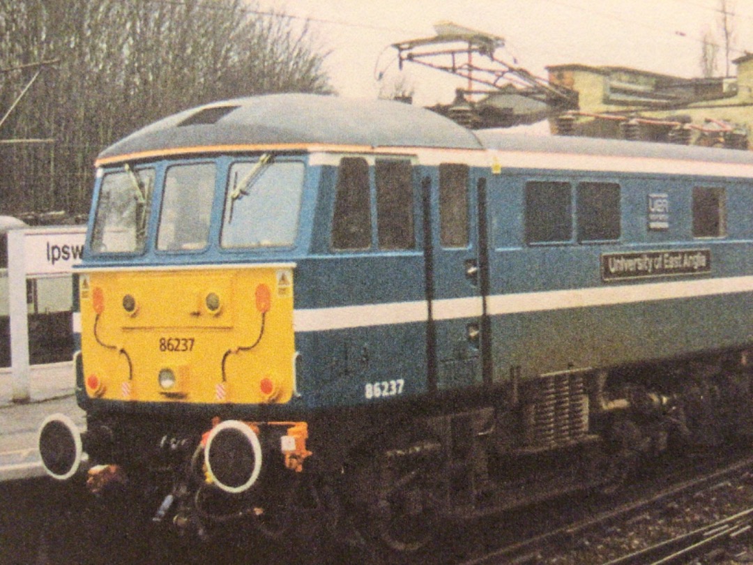 Alex Coomber on Train Siding: A Class 86. No. 86237 University of East Anglia formerly West Coast Sir Charles Halle sports it's fine new livery as it
propels a Down...