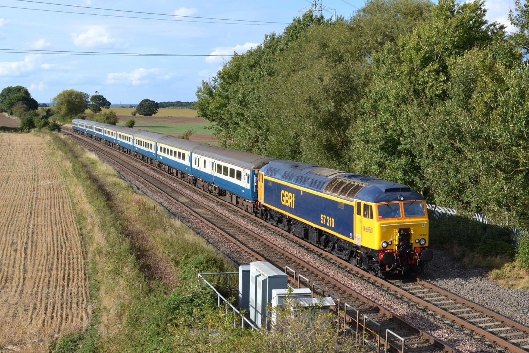 Inter City Railway Society on Train Siding: 57310 passing Portway near Tamworth with the 5A69 Burton Wetmore - Wembley Receptions 1-7 empty stock 13.9.24.