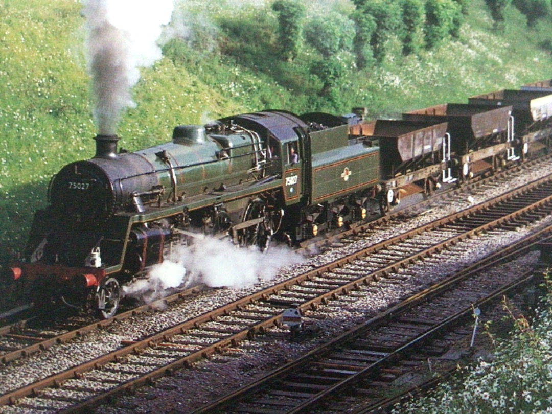 Alex Coomber on Train Siding: A British Railways Class 4MT 4-6-0 No. 75027 leaves Horsted Keynes with a permanent way train for West Hoathly. Horsted Keynes is
a rare...