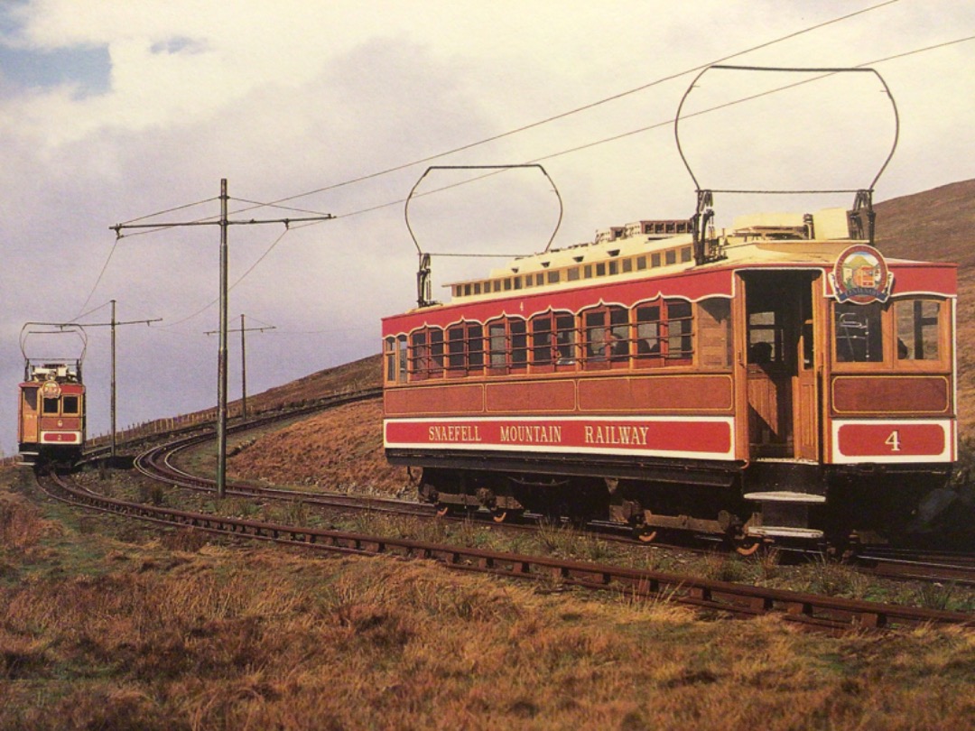 Alex Coomber on Train Siding: 2 of the 1895 vestibuled saloons of the Snaefell Mountain Railway Nos 2 and 4 pass near the summit. The steep gradients and the
need for...