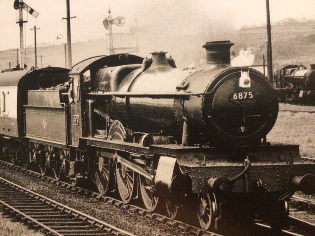 Alex Coomber on Train Siding: Looking in immaculate ex works condition. A Grange Class 4-6-0 No. 6875 Hindford Grange passes the engine shed at Long Rock in
Penzance...