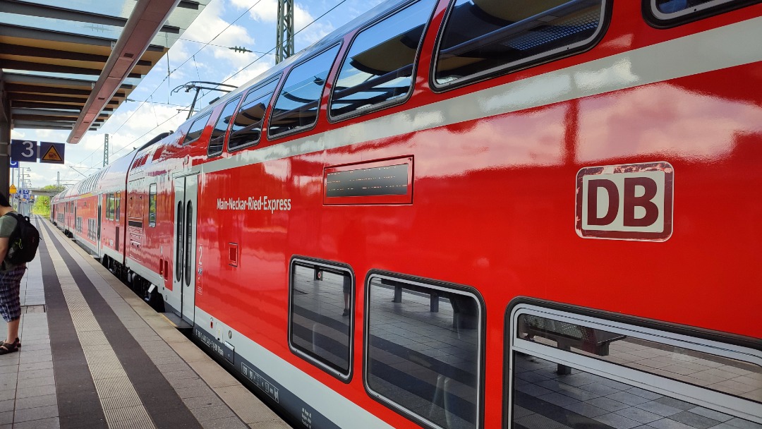 Christian Deysson on Train Siding: Main-Ried-Express to Frankfurt awaiting departure in Wiesloch-Walldorf with good humored driver getting ready to start.