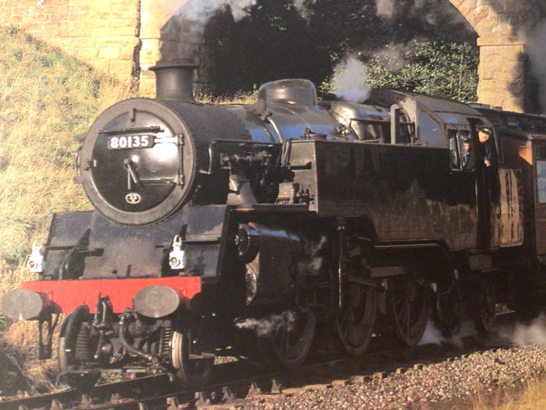 Alex Coomber on Train Siding: A BR Class 4MT 2-6-4 tank No. 80135 passes under the elegant 3 arched bridge at Darnholm with the 09:15 am from Grosmont banked by
a...