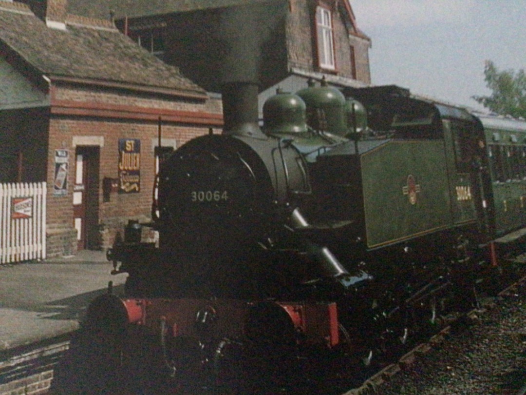 Alex Coomber on Train Siding: One of the USA 0-6-0 tanks imported during the Second World War which became BR No. 30064 waits to leave the attractive station
at...