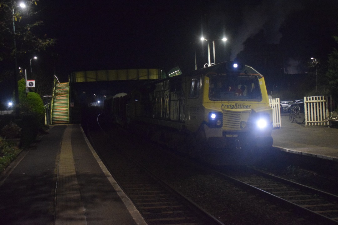 Hardley Distant on Train Siding: CURRENT: 70009 on hire from Freightliner to Colas Rail is seen at Chirk Station today arriving (Photo 1), pausing (Photo 2) and
then...