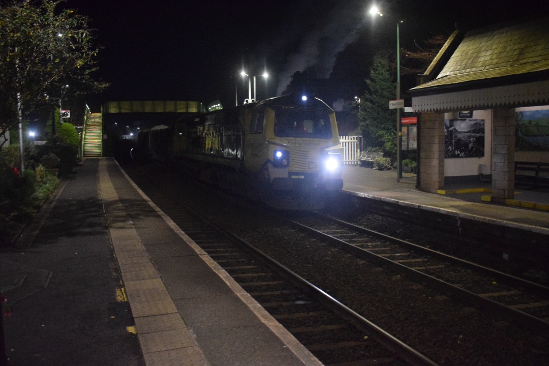 Hardley Distant on Train Siding: CURRENT: 70009 on hire from Freightliner to Colas Rail is seen at Chirk Station today arriving (Photo 1), pausing (Photo 2) and
then...