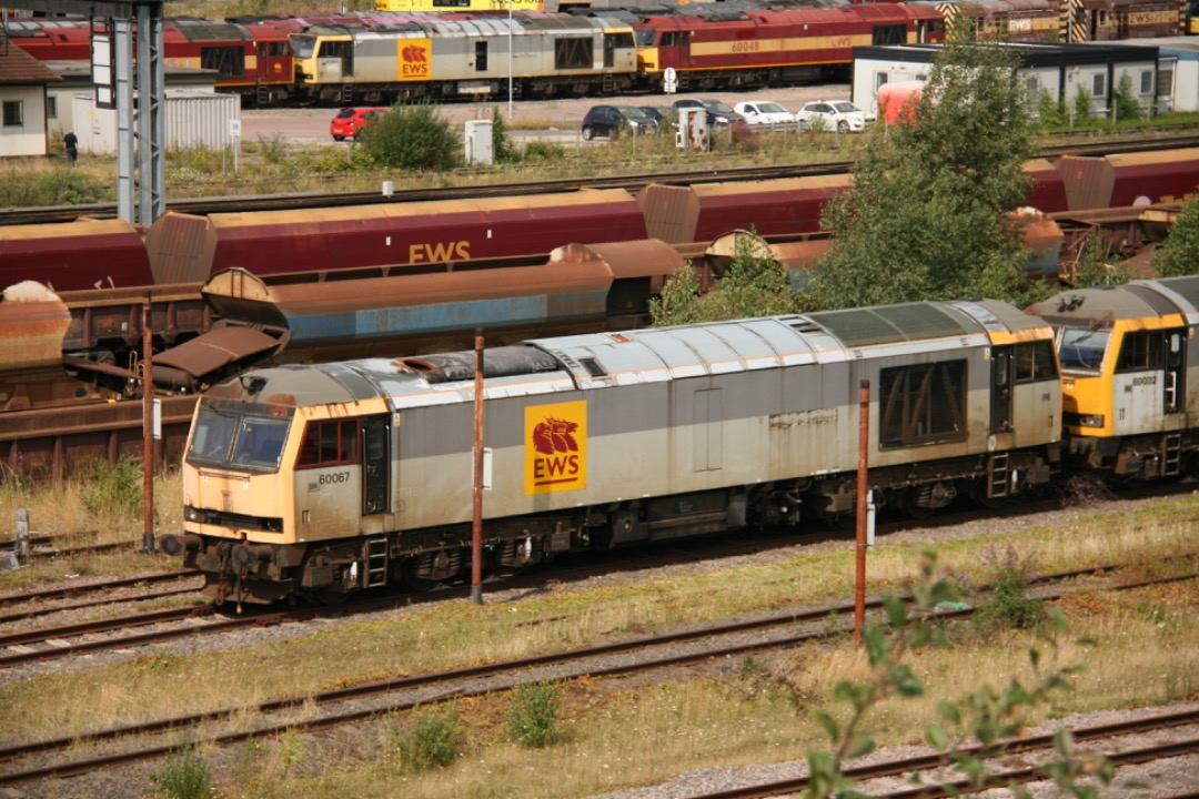 Martin Coles on Train Siding: On this day, 14th August 2014, 60067 stands in the stored lines in Toton yard, sporting original Railfreight grey with EWS logos.