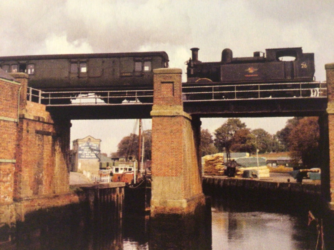 Alex Coomber on Train Siding: A Class 02 0-4-4T No.26 Whitwell crosses over the River Medina at Newport with a Cowes to Ryde Pier Head train in 1962. It closed
in...