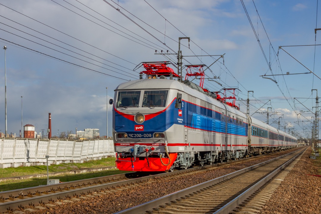 CHS200-011 on Train Siding: The electric locomotive ChS200-009 follows high-speed train No. 748 "Nevsky Express" on the Moscow - St. Petersburg route
at the St....