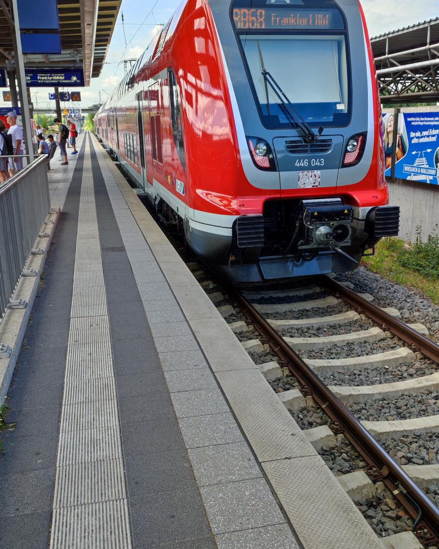 Christian Deysson on Train Siding: Main-Ried-Express to Frankfurt awaiting departure in Wiesloch-Walldorf with good humored driver getting ready to start.