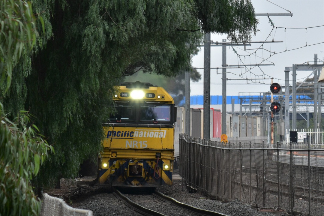 Shawn Stutsel on Train Siding: Pacific National's NR15 and NR17 races past some overgrown bushes at Werribee, Melbourne with 6MP4, Intermodal Service bound
for Perth,...