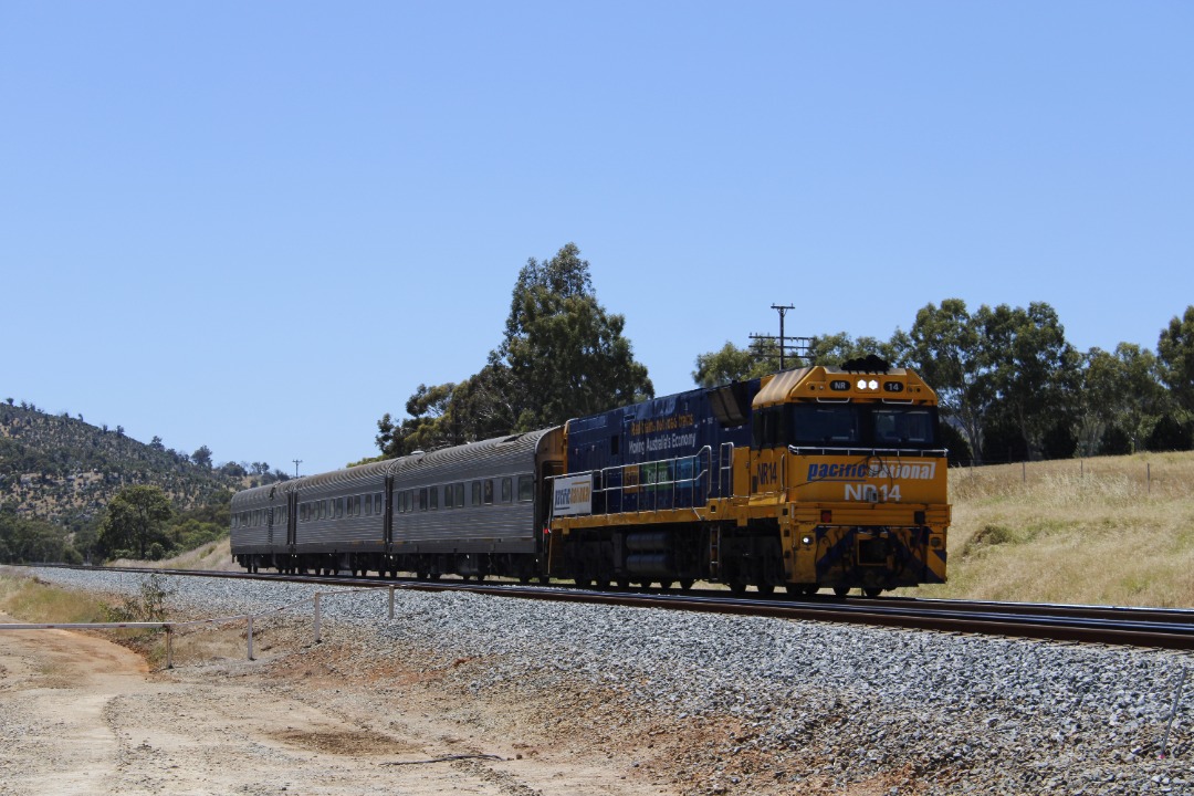 Gus Risbey on Train Siding: Pacific National's NR14 in the "Real Trains not Road Trains" livery is seen pulling the 7AK6 AK inspection cars
through Brigadoon, just up...