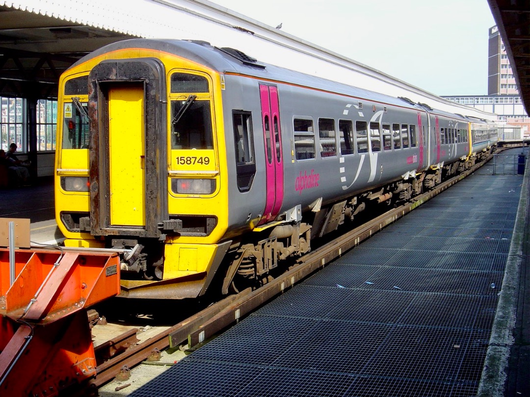 Martin Coles on Train Siding: On this day, 2nd September 2004, Alphaline liveried Class 158 Sprinter, 158749 stands at Portsmouth Harbour.