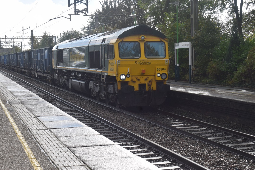 Hardley Distant on Train Siding: CURRENT: 66564 passes through Acton Bridge Station today with the 6F33 09:20 Bradbury R.T.S to Runcorn Folly Lane Waste
service.