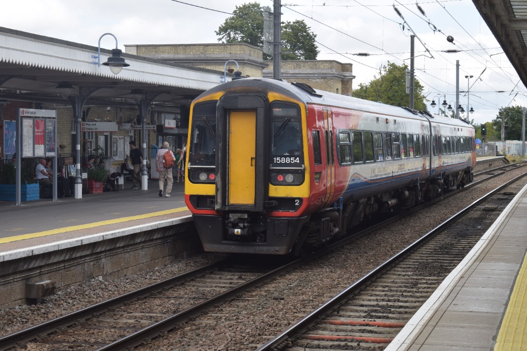 Hardley Distant on Train Siding: CURRENT: 158854 calls at Ely Station today with the 1R74 12:55 Norwich to Liverpool Lime Street (East Midlands Railway)
service.