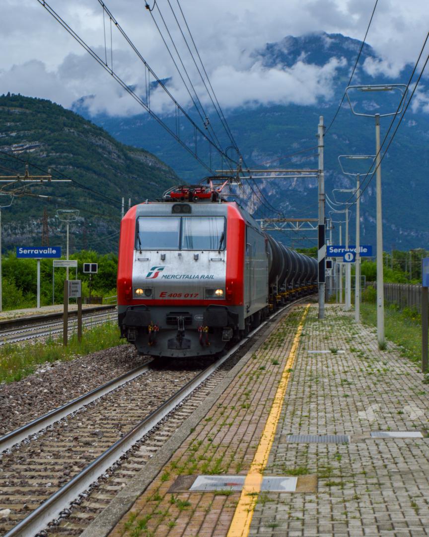 Adam L. on Train Siding: An Mercitalia Rail E.405 Class electric (Former PKP EU11 Class) is seen passing the station platforms at Serravalle with an short
string of...