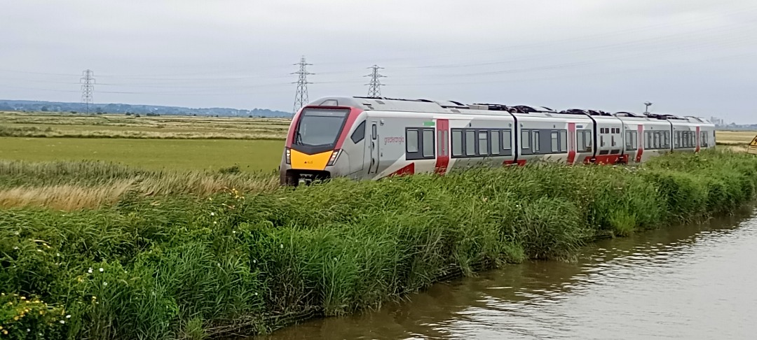 Hardley Distant on Train Siding: CURRENT: 755415 (Both Photos) travels alongside the River at the Haddiscoe New Cut on Thursday 25th July 2024 with the 2J74
12:05...