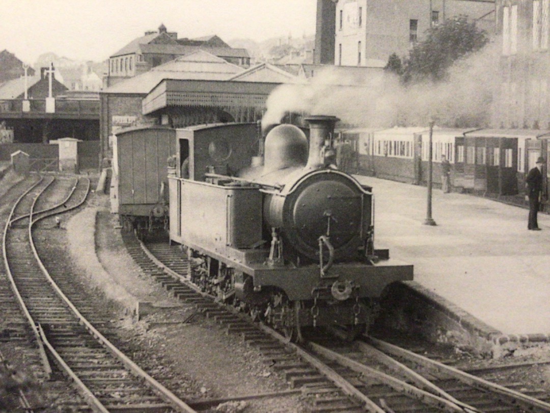 Alex Coomber on Train Siding: A County Donegal Railway Joint Committee tank 2-6-4 at rest by the platform in Londonderrys narrow gauge station which is
being...